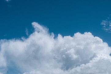 large white cloud against a blue summer sky