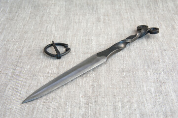 Scandinavian medieval knife, double-edged. all-metal. background.