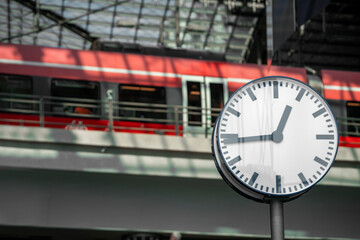 Clock on the background of a train at the railway station