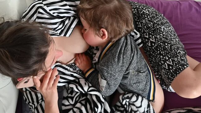 Mother is breastfeeding and talking on the phone. Diverse frames