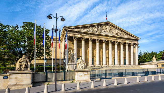 Panoramic view of the neoclassical facade, with portico, colonnade and sculpted pediment, of the Palais Bourbon in Paris, France, seat of the french National Assembly (Assemblée Nationale).
