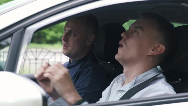 Inspector congratulates a man on passing a driving test - Powered by Adobe