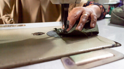 Modern sewing clothes machine on a white table