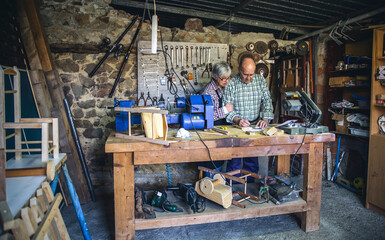 Senior couple working in a carpentry workshop