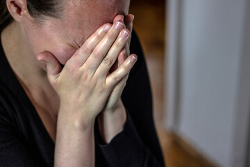 Stressed woman cry. Worried crying young girl covering her face with hands. In Human emotions and expressions and mental health.