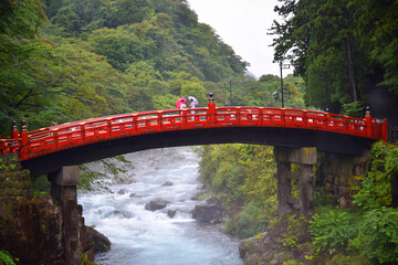 Famous Shinkyō Bridge in Nikko Japan with 2 Japanese women traditionally dressed in kimono