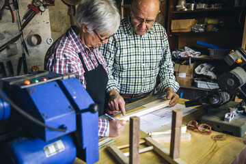 Senior couple working in a carpentry workshop