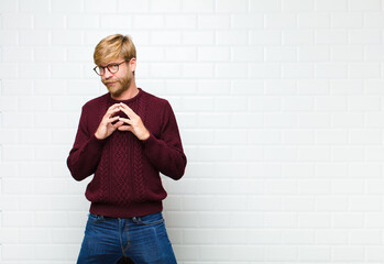 young blonde man scheming and conspiring, thinking devious tricks and cheats, cunning and betraying...