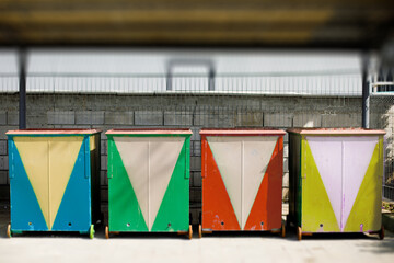 old garbage sorting containers , blue, green, yellow and red