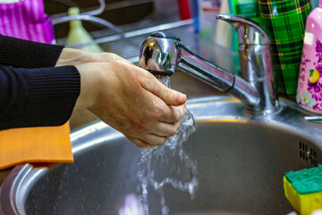 Cleaning Hands. Washing hands with water. Hygiene. Women washing her hands under running water.