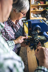 Senior couple working in a carpentry workshop
