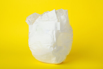 Baby diaper on yellow background, closeup. Child's underwear