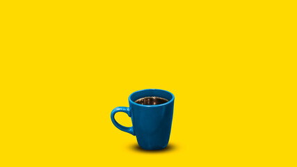 Blue cup of tea on an isolated yellow background.