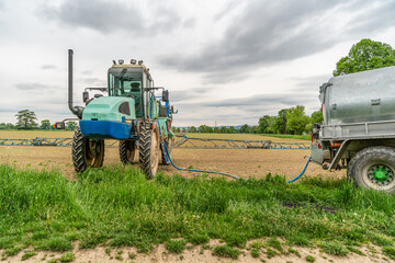 Fototapeta premium tractor adapted for spraying weeds and pests in field