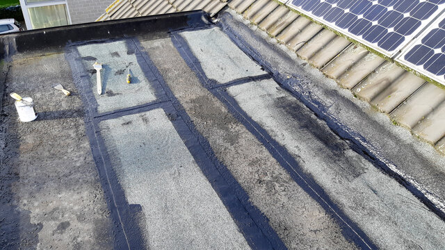 Tar Foil Roof Repair: New Patches Installed To Prevent Further Leaking From The Roof. Emergency Repair.