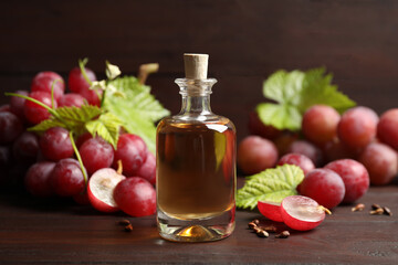 Bottle of natural grape seed oil on wooden table. Organic cosmetic