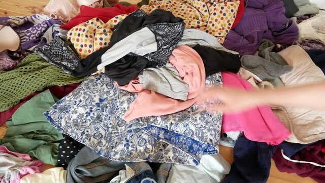 A pile of clothes is on the floor.