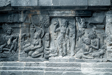 Yogyakarta Indonesia, June 4 2020 : Prambanan temple is a Hindu temple compound included in world heritage list with grass field view. Monumental ancient architecture, carved stone walls.