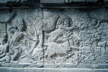 Yogyakarta Indonesia, June 4 2020 : Prambanan temple is a Hindu temple compound included in world heritage list with grass field view. Monumental ancient architecture, carved stone walls.