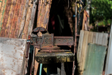 Old vise grips on a wooden bench in the backyard