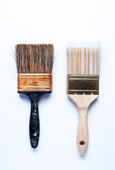 One clean and one old dirty paintbrush side by side comparison on white background