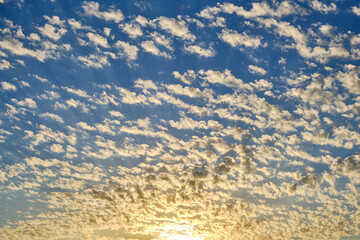 Clouds against a blue sky with a beautiful sunset.