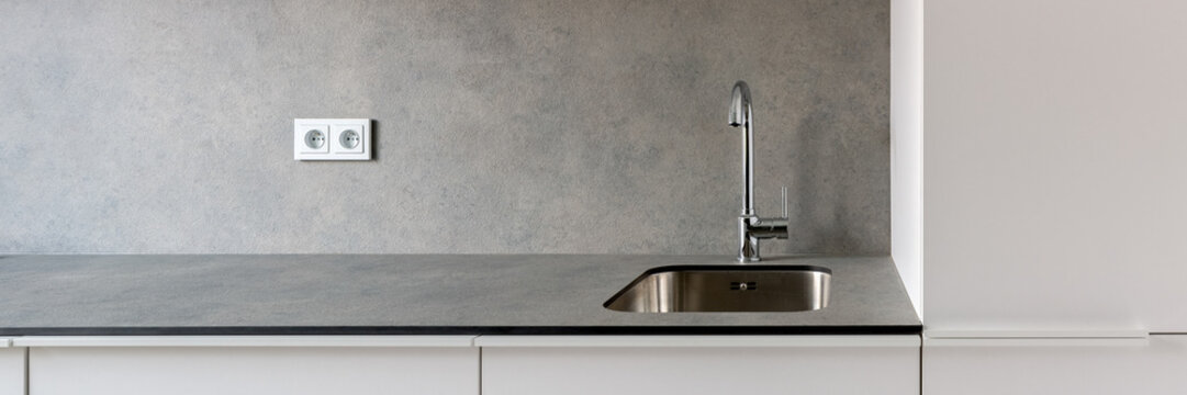 Simple kitchen sink in gray countertop, panorama