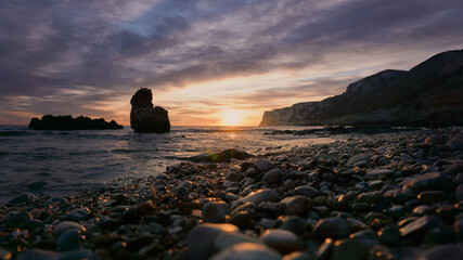Sunrise on rocky beach of the Mediterranean Sea 