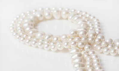 Pearl necklace on white background.