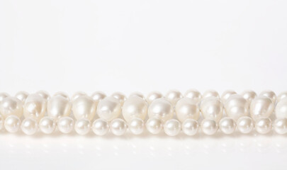 Pearl necklace on white background.