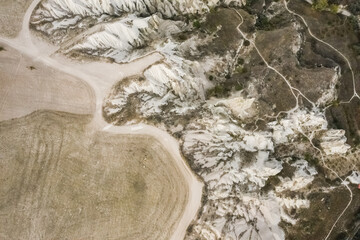 Uchisar, Nevsehir, Turkey. Landscape with picturesque far pathway, raising through rocky land and mountains.