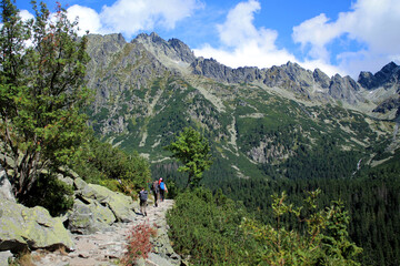 Fototapeta na wymiar Hikers climb a stone trail up to the top of mountain in High Tatras .