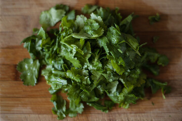 Chopped coriander on wood chopping board