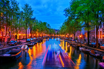 City Lights In Amsterdam Canal At Dusk In Holland, Netherlands