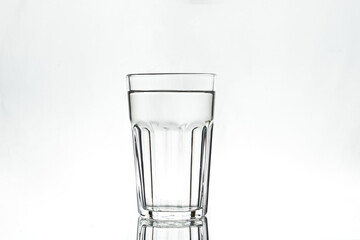 Full glass on white background. Isolated. Backlight.