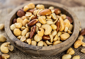 Roasted and salted nuts (close up; selective focus)