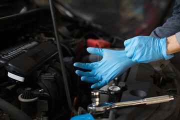 Car care, Check the engine before departure, Mechanic wearing gloves.