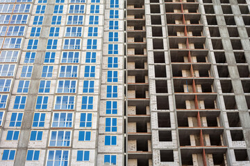 The construction of a multi-storey building in the city. one house at different stages of construction