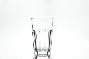 Empty glass on white background. Isolated. Backlight.