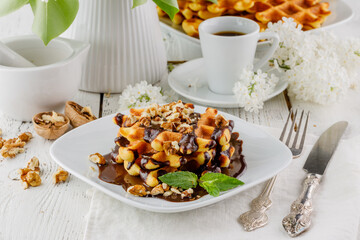 Close up belgian waffers on plate with chocolate for breakfast