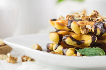 Close up belgian waffers on plate with chocolate for breakfast