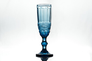 Full blue wineglass on white background. Isolated. Backlight.