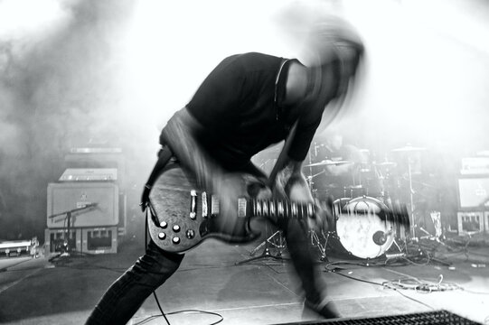 Wild rock guitarist playing on stage