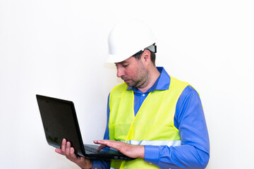 Attractive caucasian Technician Holding Laptop Over White Background.Makes all kinds of grimaces-eyes closed, upset, thinking, shows thumb up, and ok gesture...