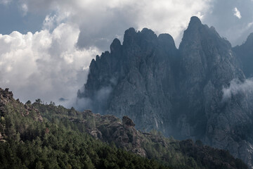 Bavella needles at Corsica I Forchi di Bavedda mountain with clouds