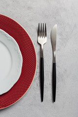 Close up table set with silverware on gray concrete