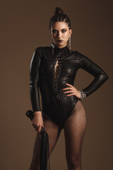 Attractive hot girl in leather suit and cuffs isolated on white