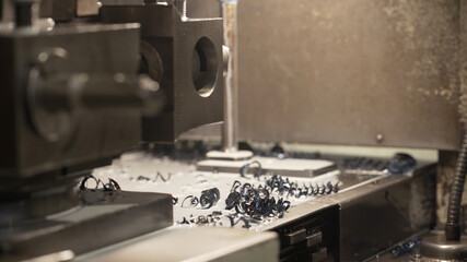 Machine tools for metal working. A metal workpiece is machined by an electric machine. Metal shavings. Industrial theme. Metalworking and mechanical engineering.