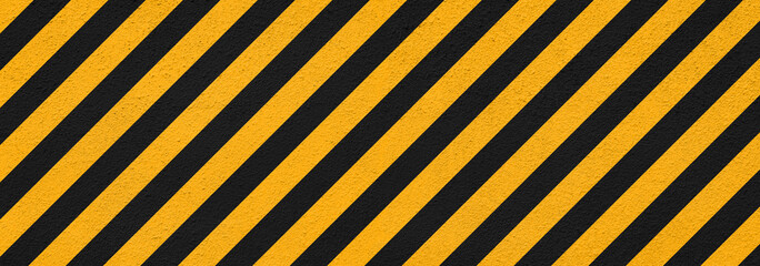banner of plaster wall with black and yellow restricted area marking