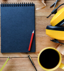 Notepad, coffee and construction tools on the table